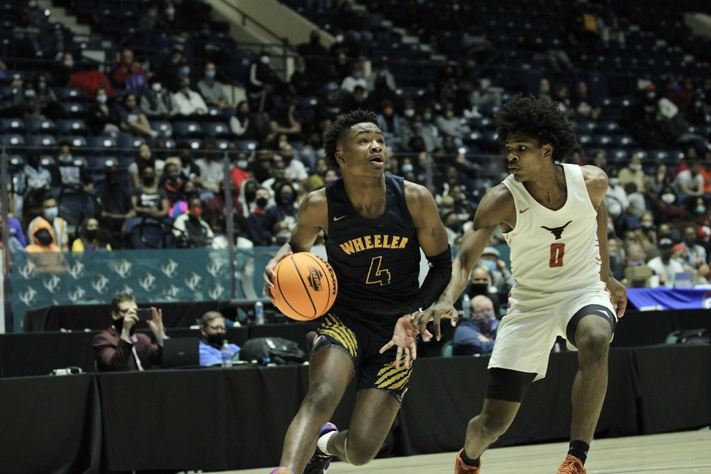 Isaiah Collier drives with Scoot Henderson defending him. 